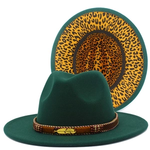 Detailed shot of dark green fedora with leopard print lining and feather charm