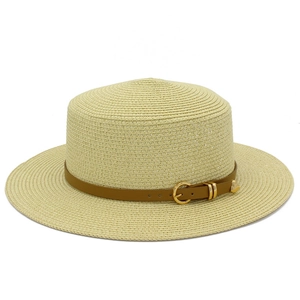 Detailed view of woven boater hat with flat top and brown leather band buckle detail