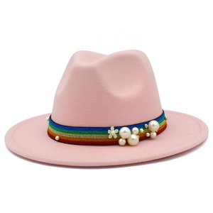 Detail of pink wool fedora hat featuring rainbow striped band with pearls and floral accents