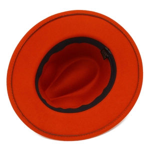 Detail view of bright orange wool fedora showing black sweatband and high-quality stitching