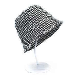 Detail of classic black and white houndstooth pattern on a vintage wool bucket hat for women