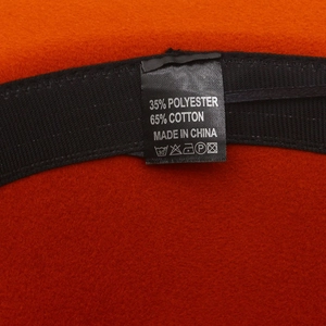 Detail view of the orange wool fedora interior showing the cotton blend fabric label