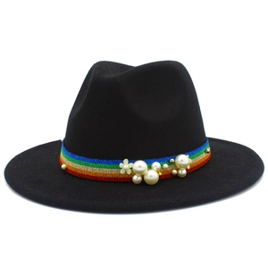 Detail of black wool fedora featuring a rainbow ribbon band with pearls and a flower