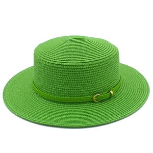 Detailed close-up of woven green boater straw hat with matching leather belt and gold buckle