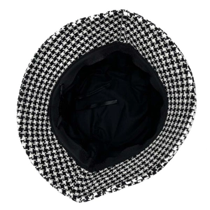 Detail of adjustable black ribbons and soft inner lining inside houndstooth bucket hat