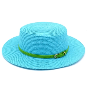 Detail of blue straw boater hat featuring a green faux leather belt and gold buckle