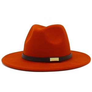 Detail of burnt orange fedora hat with wide brim and black belt with gold metal buckle