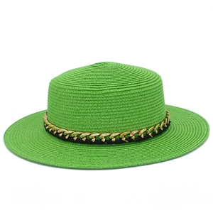 Détail du chapeau canotier vert vif avec chaîne dorée et ruban tissé noir décoratif