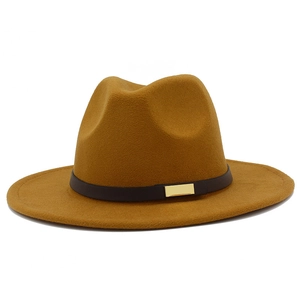 Detail view of the high-quality mustard wool fedora hat with black band and gold buckle