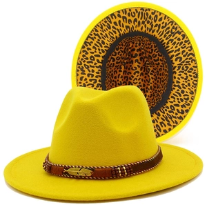 Detail view of yellow wool fedora hat with metal feather decor and leopard print brim