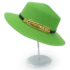 Bright green straw Panama hat with black leather band and gold metal feather ornament
