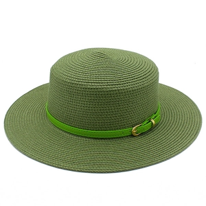 Detailed macro view of olive green straw hat weave with green leather belt and gold buckle