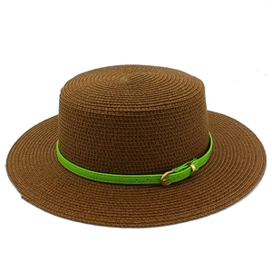 Detailed macro view of the dark brown woven boater hat with a green leather belt