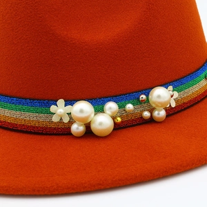 Elegant wool felt fedora hat in burnt orange with rainbow ribbon and pearl decorations