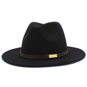 Detail of classic black fedora hat with brown leather belt and gold buckle accent