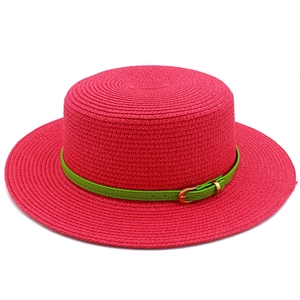 Bright rose pink straw sun hat with decorative green belt and gold buckle for summer beach trips