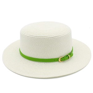 Close-up of white straw boater hat featuring a vibrant green leather band and gold buckle