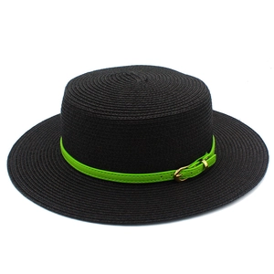 Close-up of black straw hat featuring a vibrant neon green leather band with gold buckle