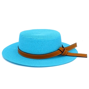 Close-up of a bright blue straw boater hat with a brown leather decorative band