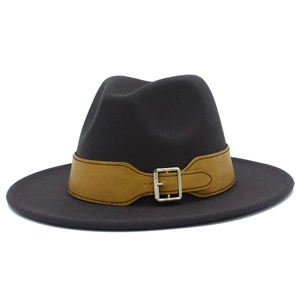 Detail view of dark grey wool fedora hat featuring a camel leather band and silver buckle