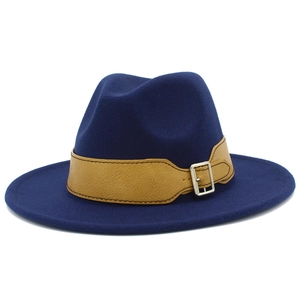 Detail of navy blue felt fedora hat featuring a brown leather strap and silver metal buckle
