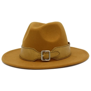 Detailed close-up of brown fedora hat featuring a leather band and silver metal buckle