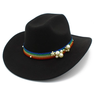 Detail of black wool fedora featuring rainbow ribbon band with pearls and white flower