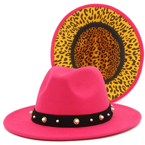 Detailansicht des fuchsiafarbenen Fedora-Hutes mit Perlenband und gelbem Leopardenfutter