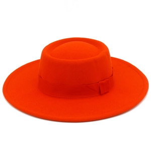 Detail of a bright orange wool felt wide brim hat with a matching grosgrain ribbon band