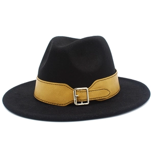 Detail of black fedora hat featuring a brown faux leather band and silver metal buckle