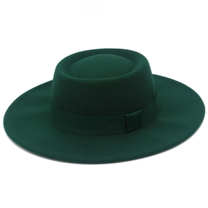 Detail view of smooth wool felt texture and matching ribbon on dark green bolero hat