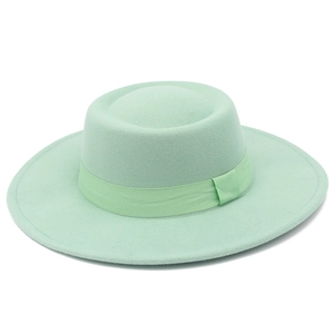 Macro shot of mint green wool felt fedora with ribbed ribbon and flat brim detail
