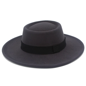 Close-up of classic grey wool fedora with flat brim and elegant black decorative ribbon