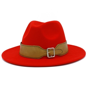 Close-up of a red wide-brim fedora hat with a khaki faux leather buckle belt detail