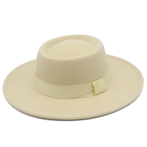 Detailed texture of a cream wool felt flat top fedora hat with matching ribbon trim