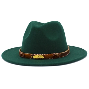 Detail of dark green fedora hat featuring a gold feather buckle and beaded ethnic band