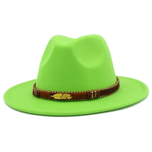 Detail of green wool fedora hat featuring a brown braided band and gold feather pin