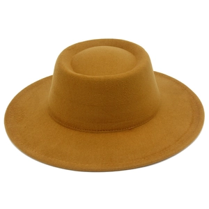 Détail de la texture en laine et des coutures sur ce chapeau fedora jaune moutarde élégant