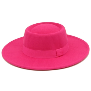 Detail of fuchsia wool fedora hat featuring wide brim and matching decorative ribbon band