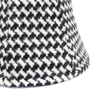 Detailed close-up showing the soft wool-like texture of the black and white houndstooth hat