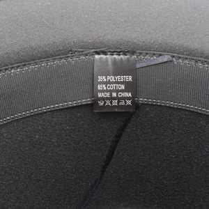 Detailed close-up of the fedora hat's inner black sweatband and cotton blend label