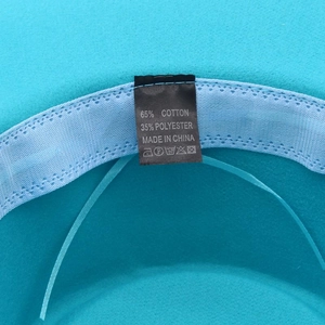 Detailed interior of blue wool fedora showing sweatband and 65% cotton label