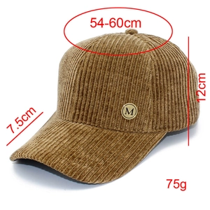 Detail showing dimensions of brown corduroy baseball cap with metal M logo and curved brim