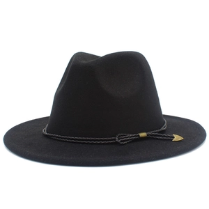 Close-up of black wool fedora featuring a vintage brown cord and golden arrow pendant