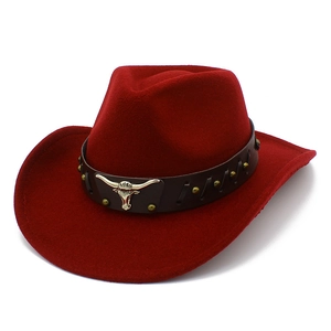 Detail of red wool felt cowboy hat featuring a leather band with silver steer head ornament