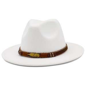 Close-up of white wide-brim wool fedora with brown ethnic band and golden feather pin