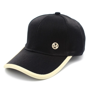 Fashionable black baseball cap with M logo and cream brim piping for sun protection