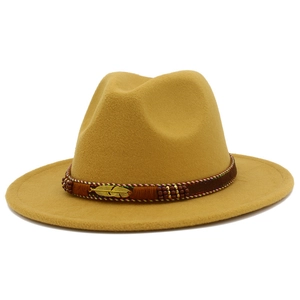 Detailed close-up of mustard wool fedora featuring a feather charm and beaded band
