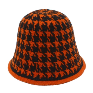 Detailed close-up showing the orange houndstooth knitted texture of this winter bucket hat