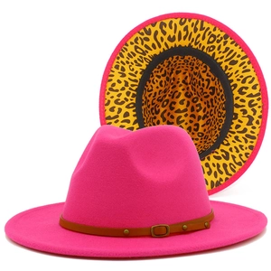 Detail of fuchsia wool fedora hat featuring leopard print lining and leather belt